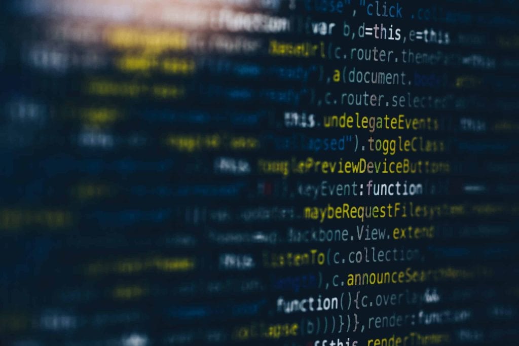 Close-up of a computer screen displaying blurred lines of code, set against a dark backdrop. Pastel hues illuminate words like "function" and "toggle." For those in need of electronic recycling in Atlanta, GA, discreet drop-off boxes are available to keep your tech refreshed responsibly.