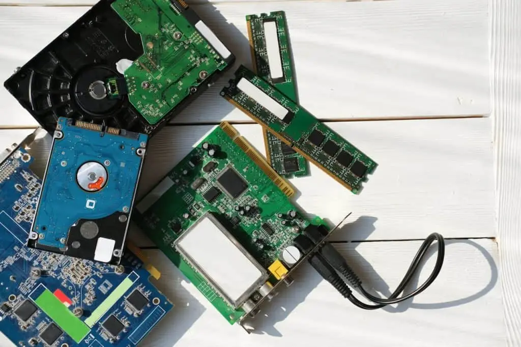 Electronic circuit boards and microchips piled together, representing e-waste components for recycling and sustainable electronics disposal.
