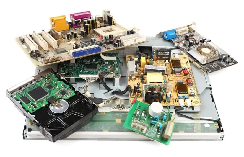 A collection of various computer components, including circuit boards, a hard drive, a motherboard, and other electronic parts, arranged on a white background. These pieces, available at our Electronics Atlanta GA hub, showcase different shapes, colors, and sizes.