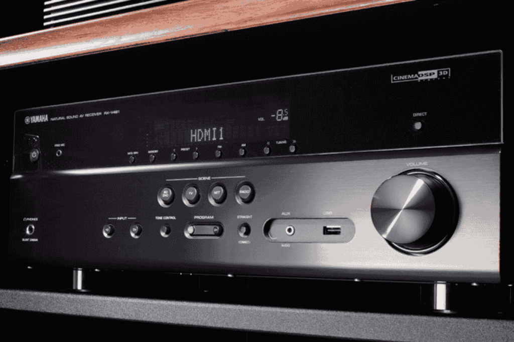 Close-up of a black audio-video receiver with a large volume knob and various buttons and ports on the front panel. The digital display shows "HDMI 1" and a volume level of "-8.5". As electronics recycling becomes vital, consider proper disposal for tech like this when upgrading.