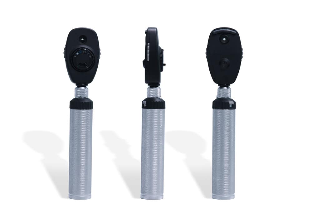 Three ophthalmoscope tools with silver handles and black tops are shown from different angles against a white background, highlighting the importance of electronics recycling to prevent e-waste disposal issues.