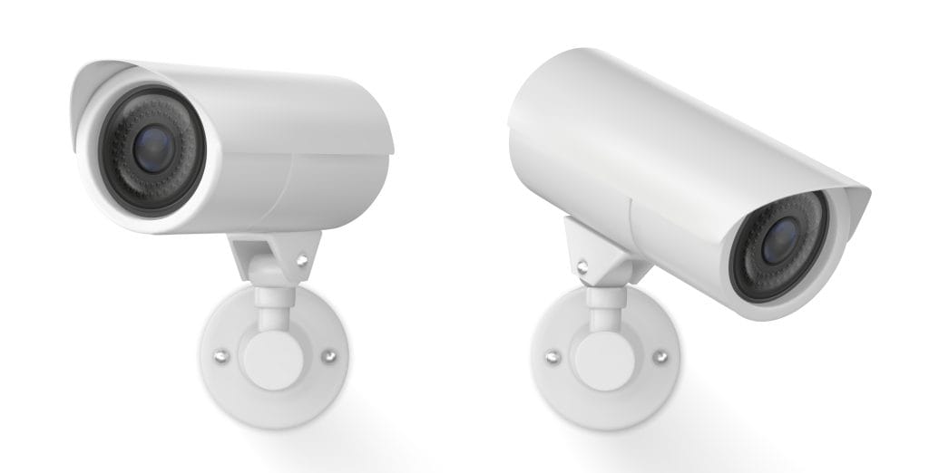 Two white security cameras mounted on a white background. Each camera is cylindrically shaped with a black lens in the center. They are shown from a side angle, highlighting their sleek, minimalist design&mdash;ideal for those committed to sustainable electronics recycling practices.