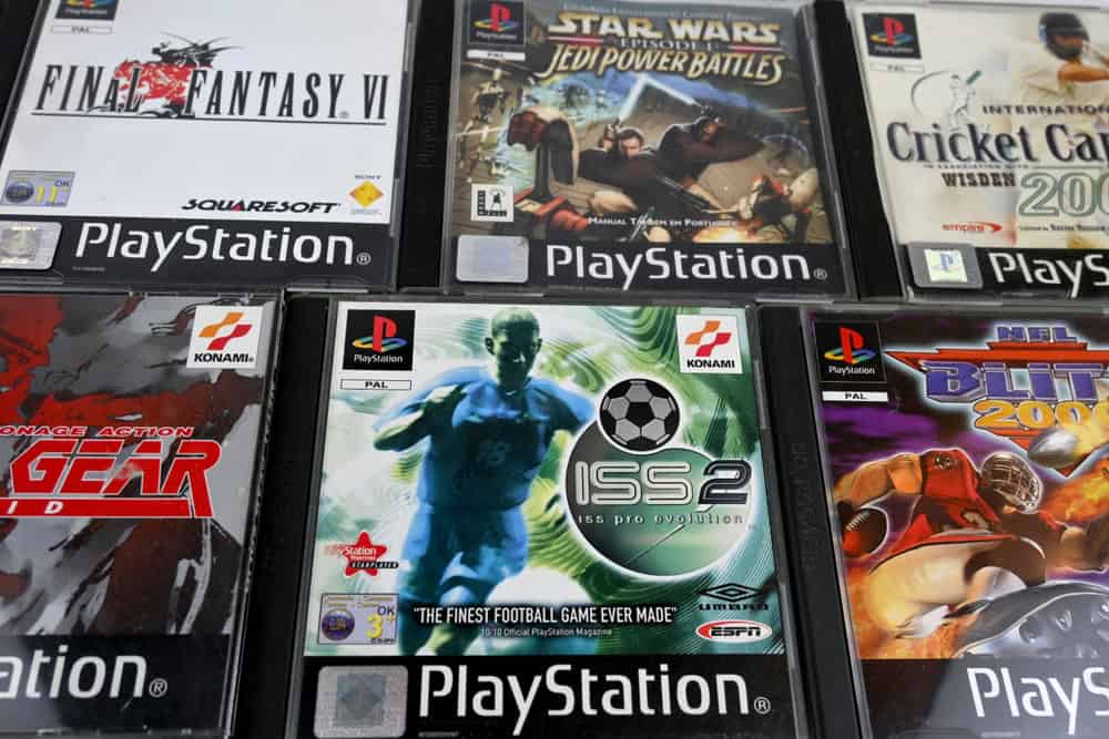 Close-up of several PlayStation game cases. Titles visible include "Final Fantasy VI," "Star Wars: Jedi Power Battles," and "ISS Pro Evolution 2." Each features distinctive cover art and logos, reminding us to consider E-waste disposal as we enjoy our gaming treasures.