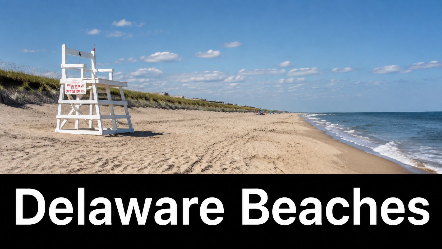 A lifeguard stand on a sandy beach under a blue sky with clouds in Delaware.