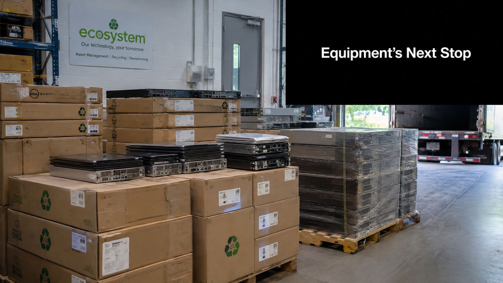 A stack of packaged IT hardware and servers inside an industrial material recovery facility warehouse.