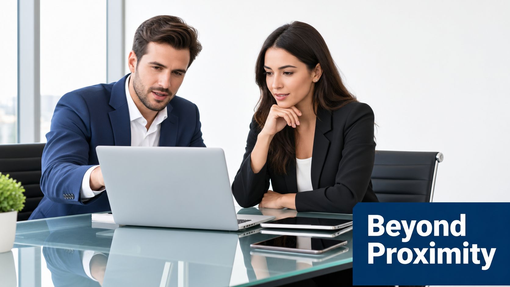 A professional man and woman in business attire collaborating on a project using a laptop computer.