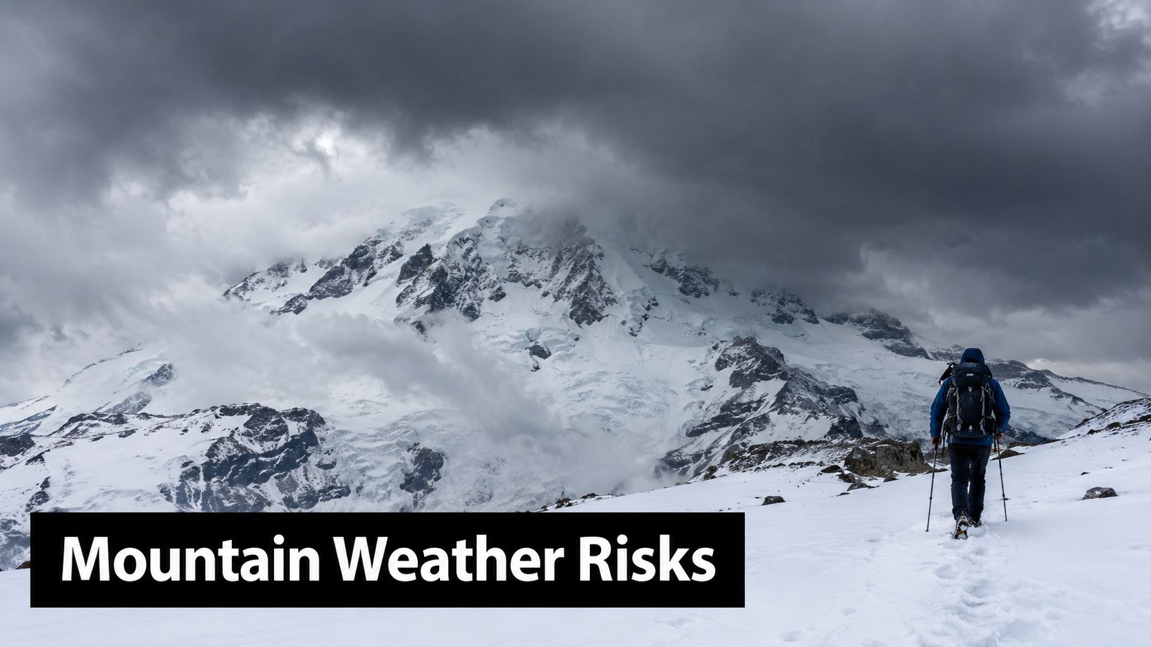 A hiker with a backpack walks through snow toward a massive, storm-cloud-covered mountain peak.